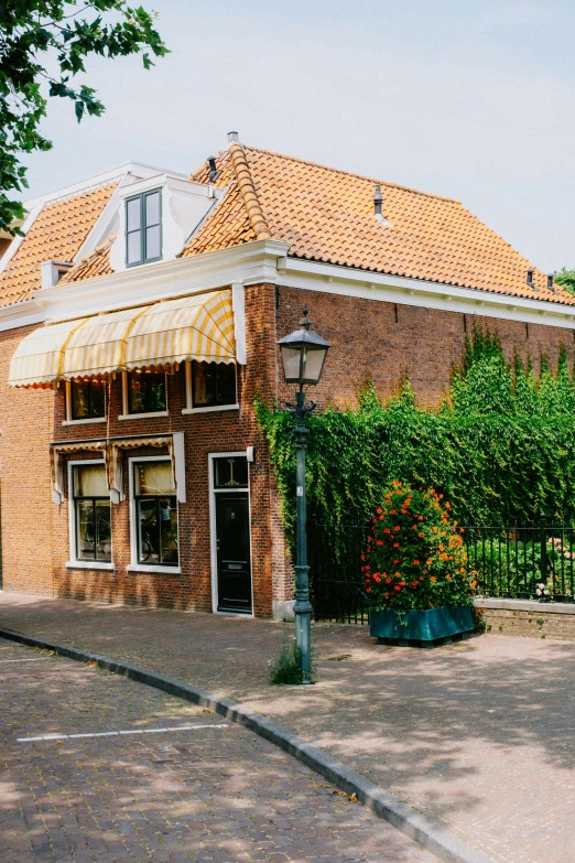 a small building in front of a road with a clock on the outside