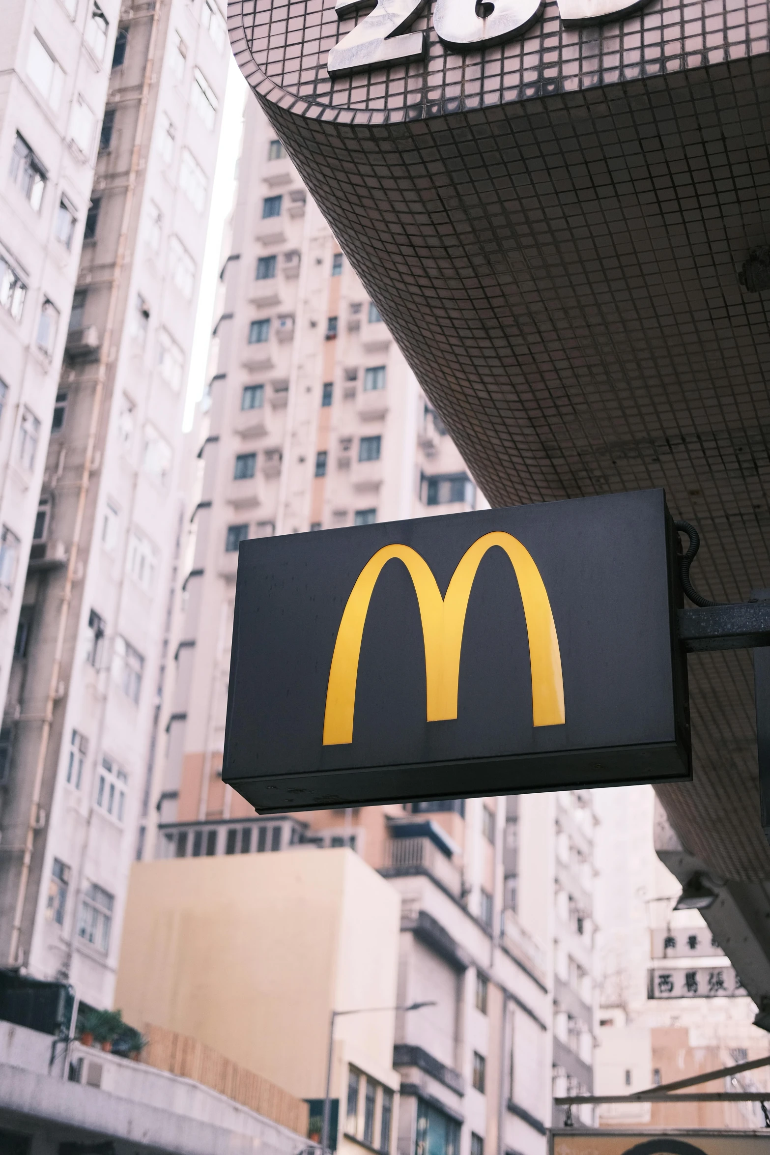 a mcdonald's sign is suspended over the city street