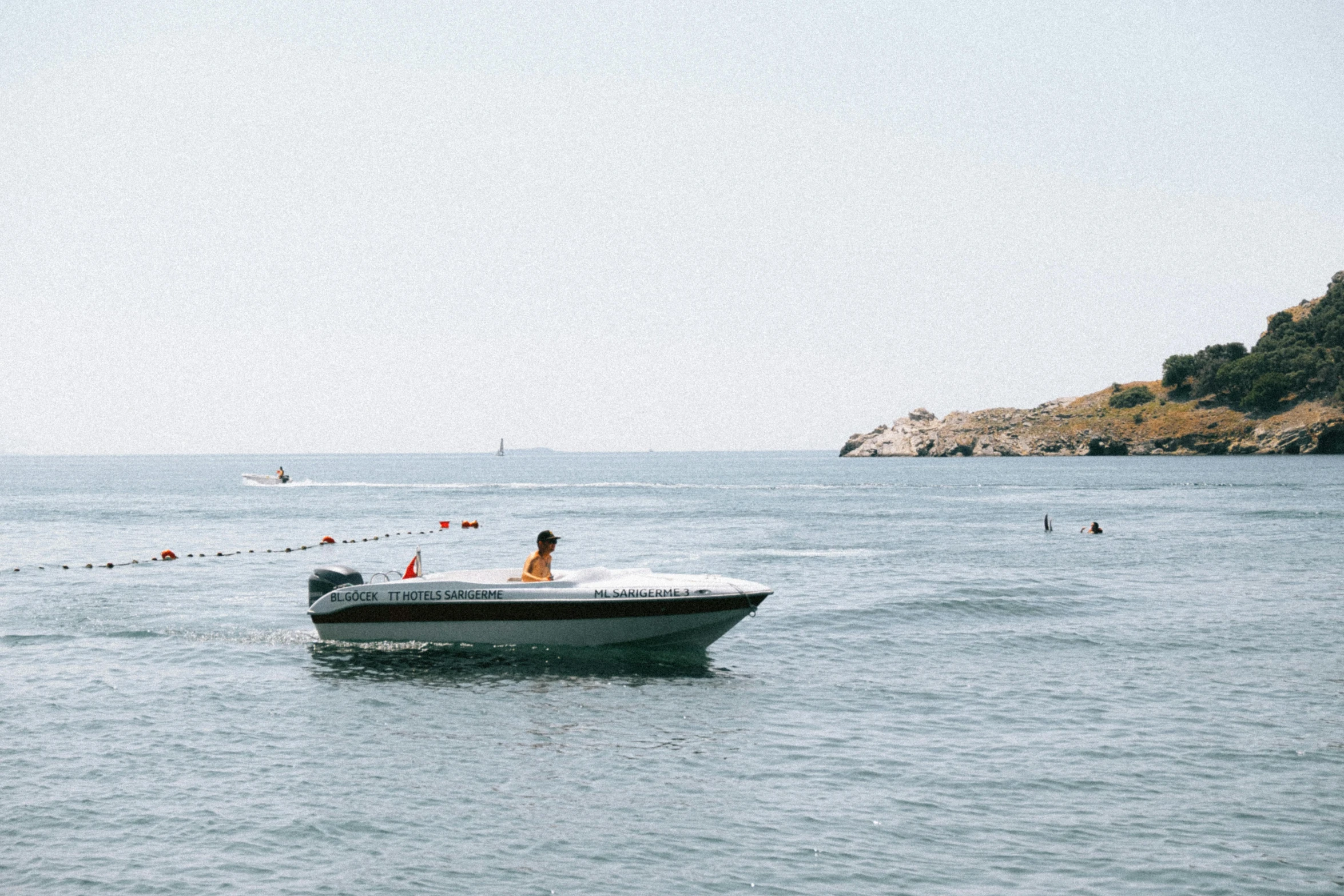 a person sitting in the side of a motor boat