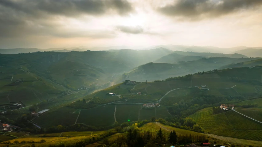 a mountain valley that is covered with clouds