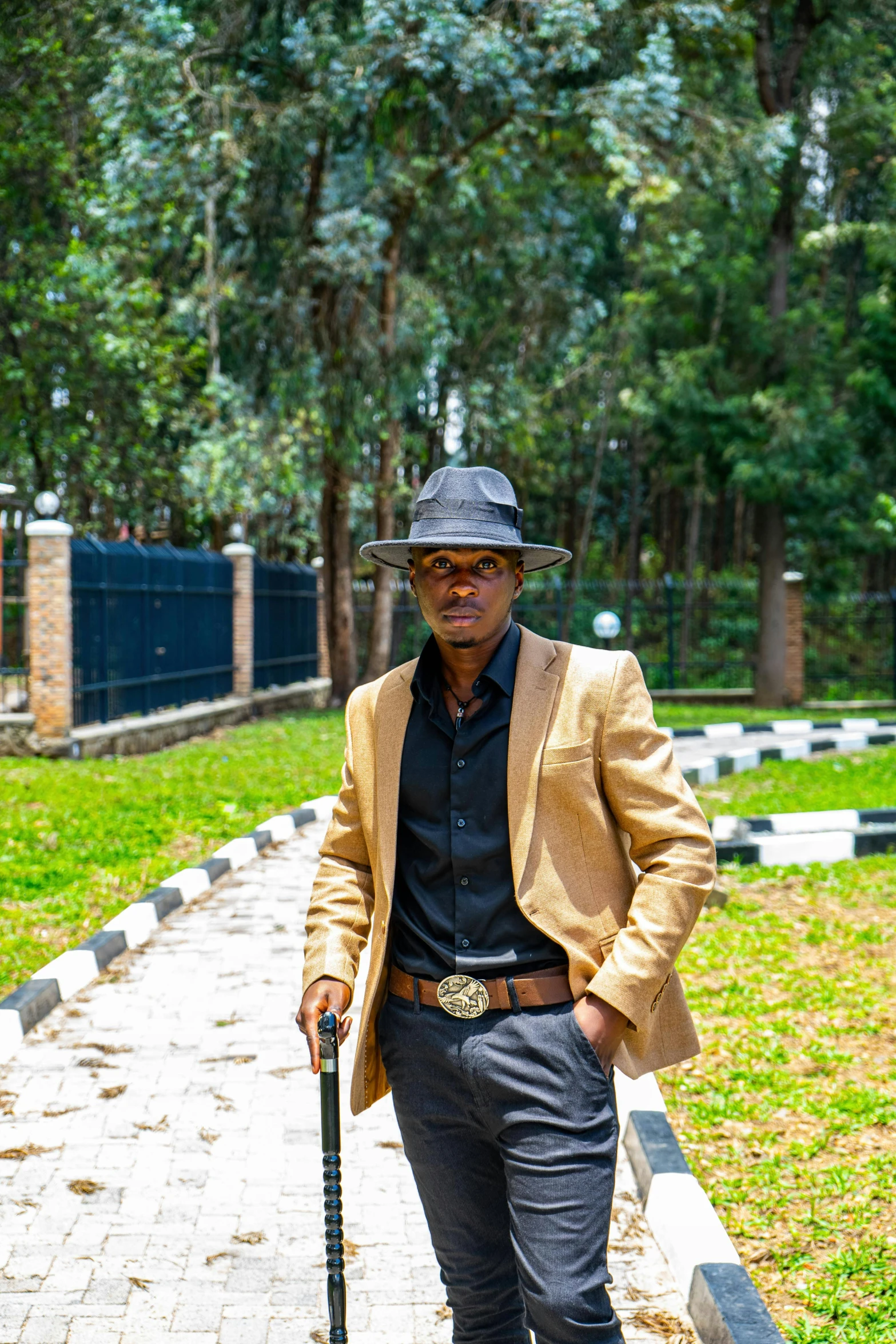 a man walking down the road holding a cane