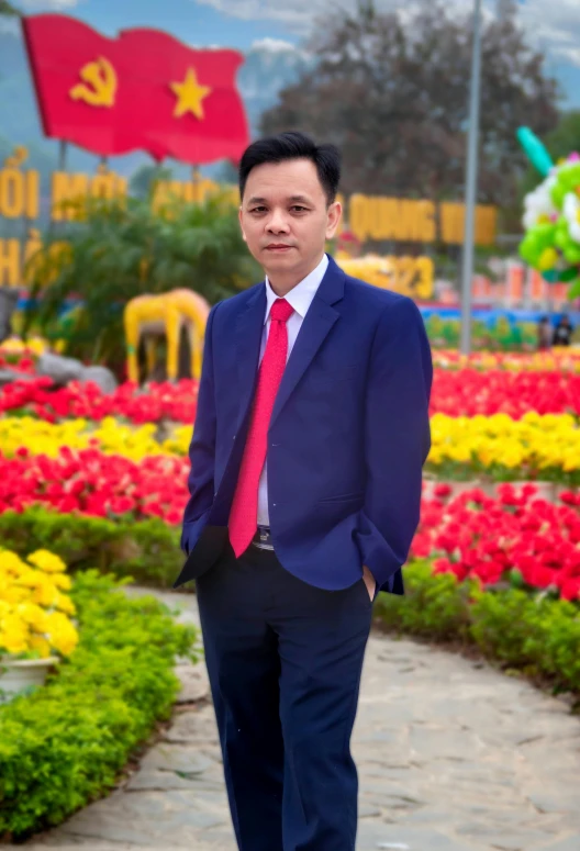 a man is standing near many flowers and flags