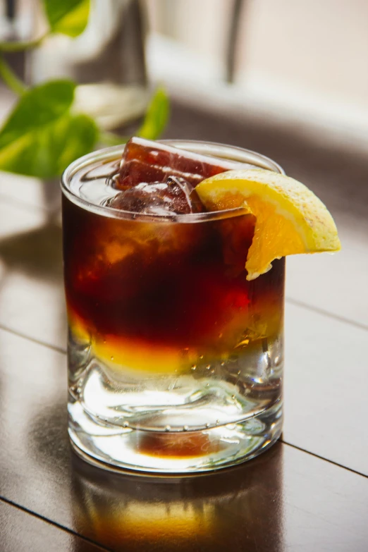 glass with ice and water, with yellow lemon wedge on the rim