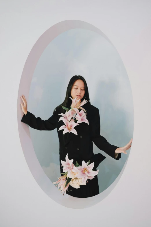 a woman posing behind flowers in a circular po