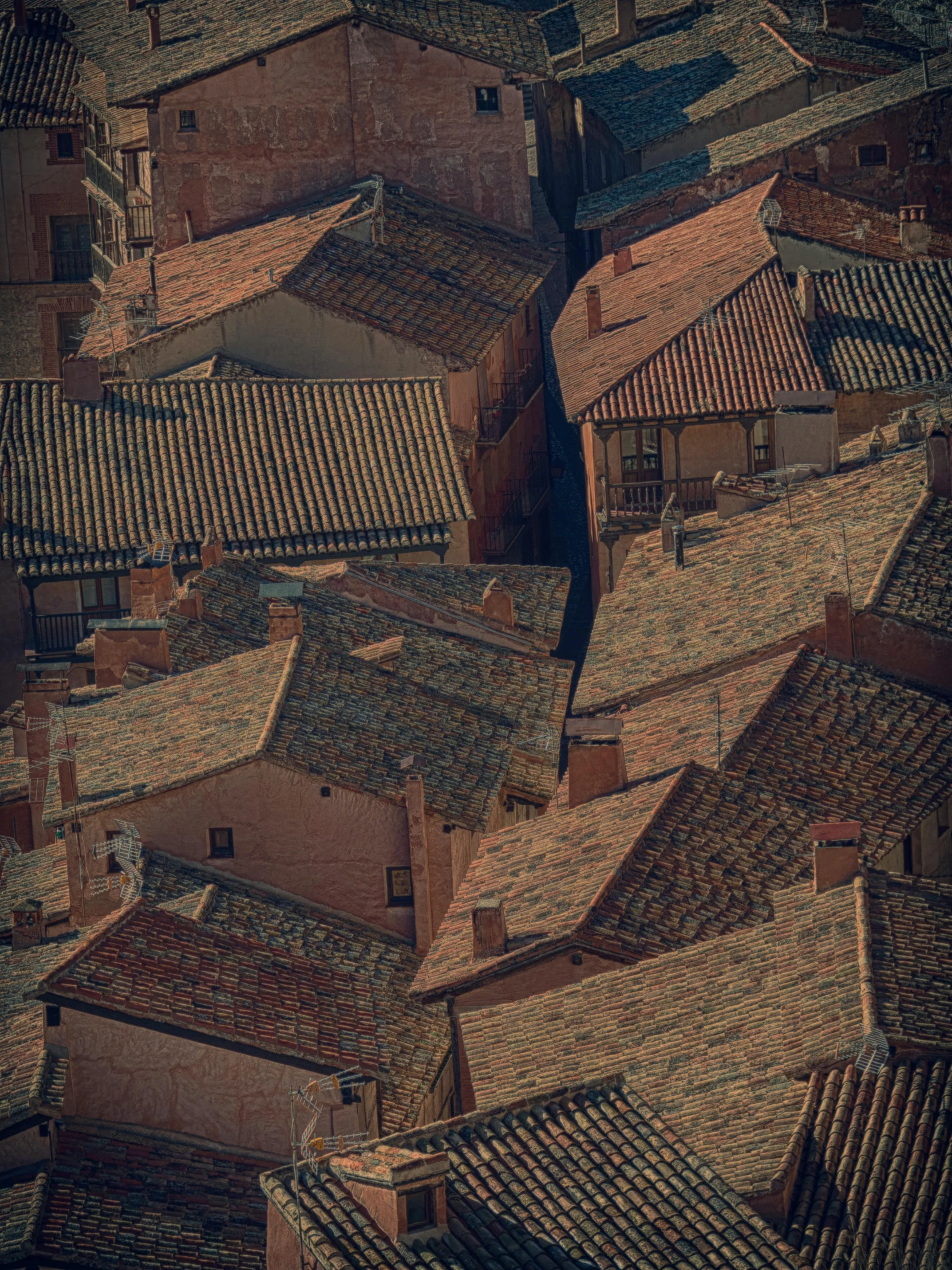 the roofs of several buildings with tile roofs