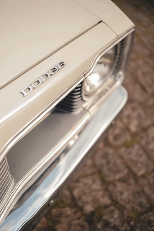 a close up view of the front end of a white classic car