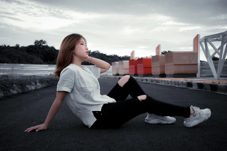 a woman is sitting down with her foot on the ground