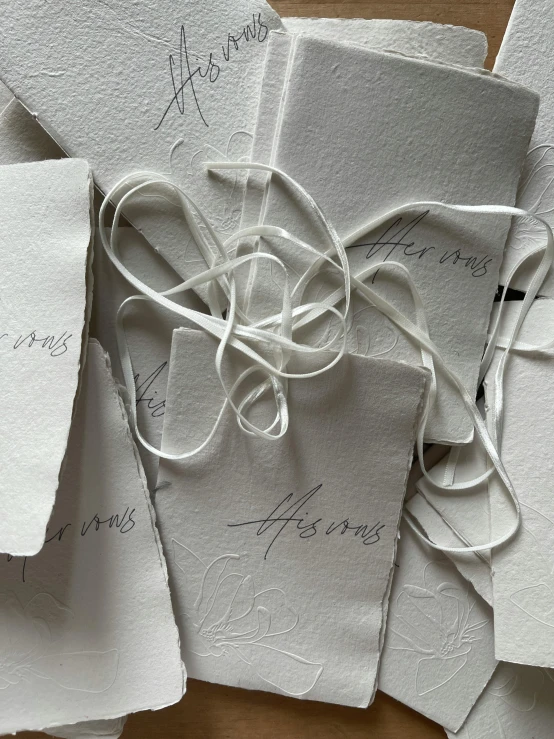 some sheets of white paper with string tied down the middle