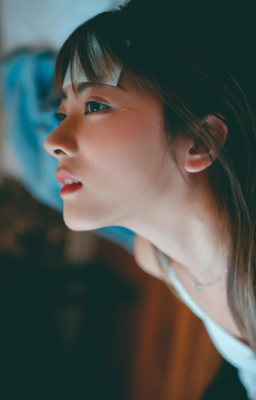 woman with brown hair wearing ear rings looking away