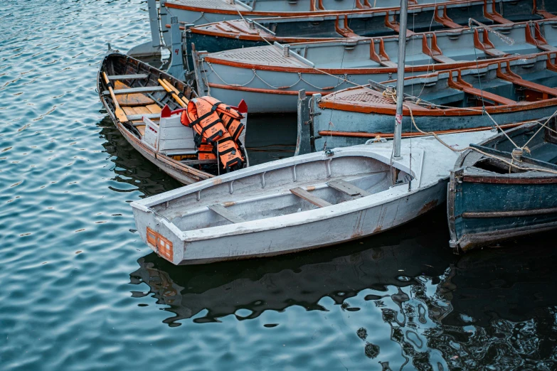 several small boats sitting in the water