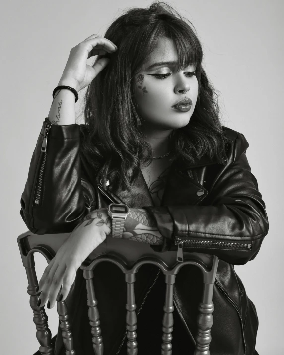 a woman sitting in a chair with her hair blown back