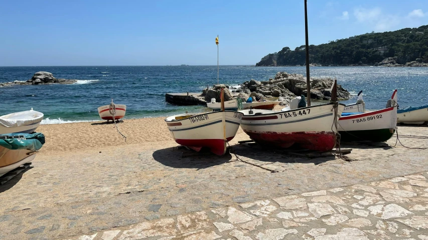 two row boats docked near the water in a secluded cove