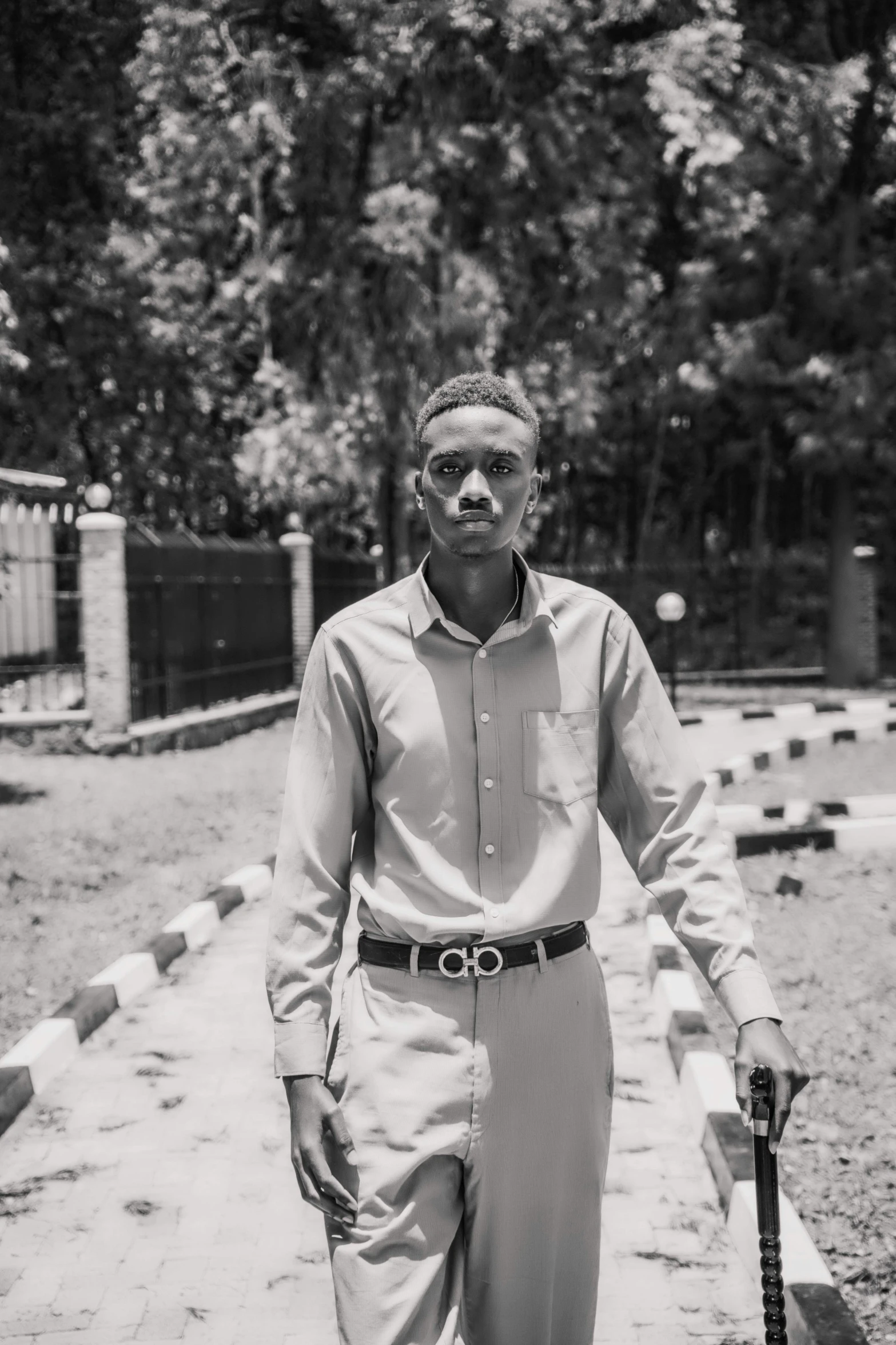 man standing and looking back on a side walk