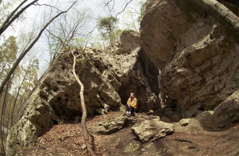 a person standing on a mountain path near rocks