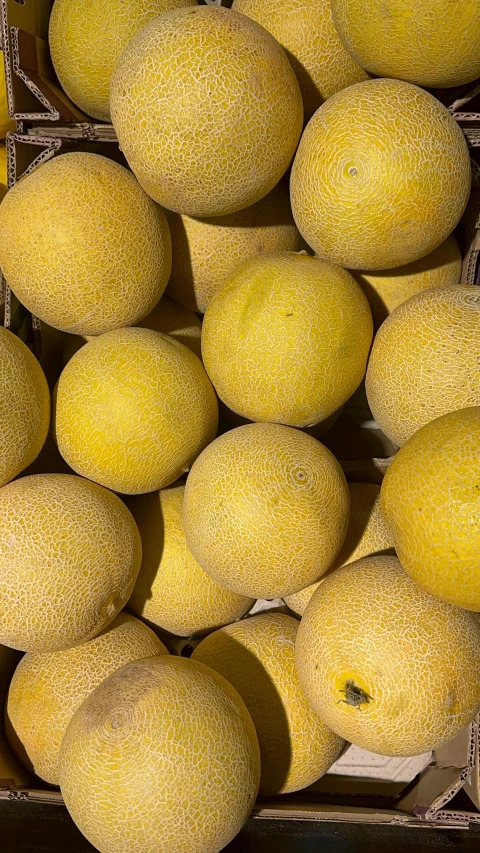 several fruit sitting in a display in boxes