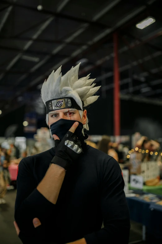 a man wearing an angry costume and blind folded with his arms crossed