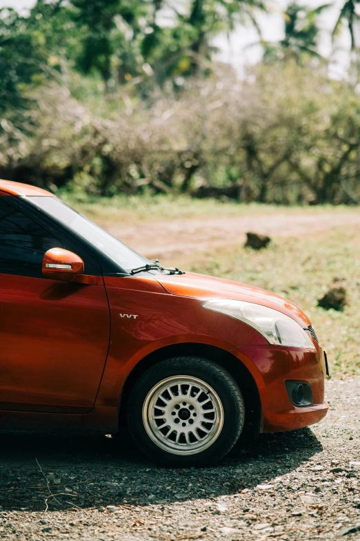 a smart car parked on a dirt road