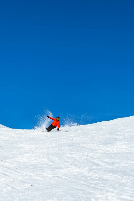 a person snowboarding down a very steep slope