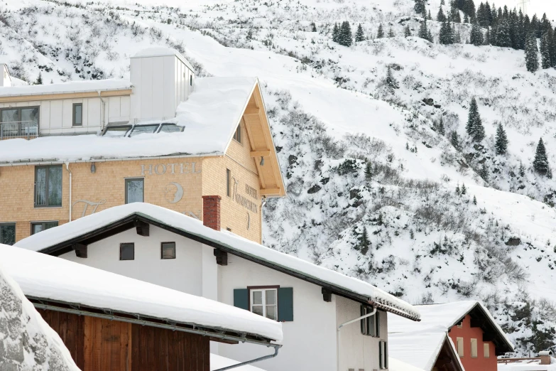 a house is perched on top of a snowy mountain