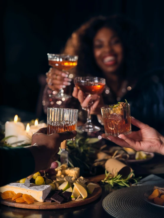 three people clinking their hands to drink while toasting