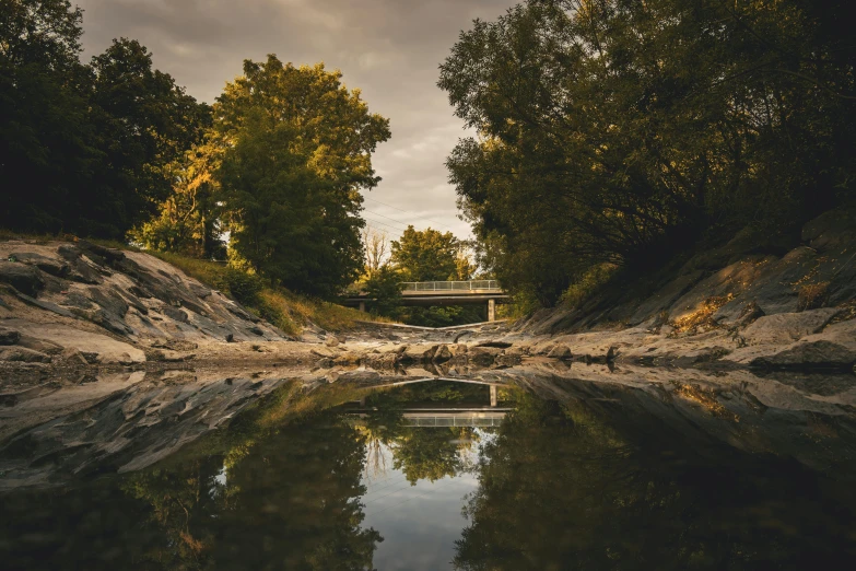 a lake with no water near a road bridge