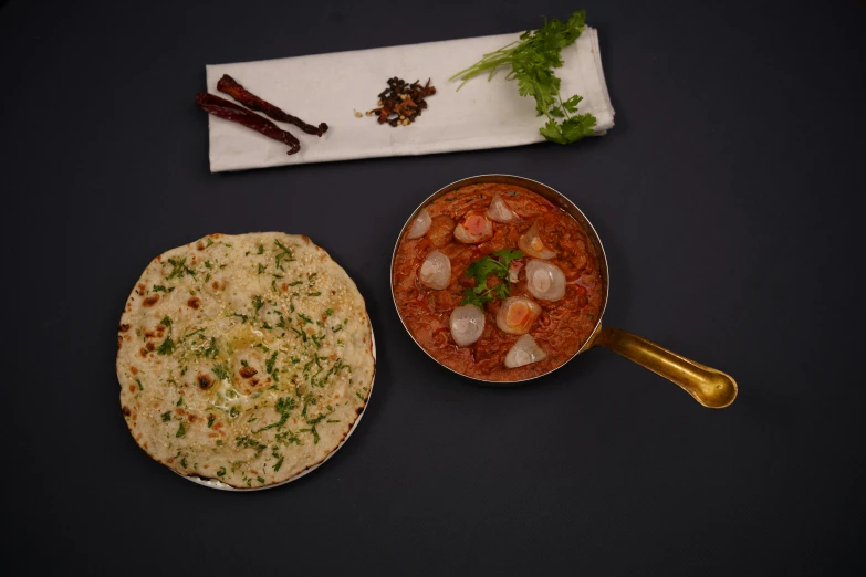 a table topped with two bowls filled with food