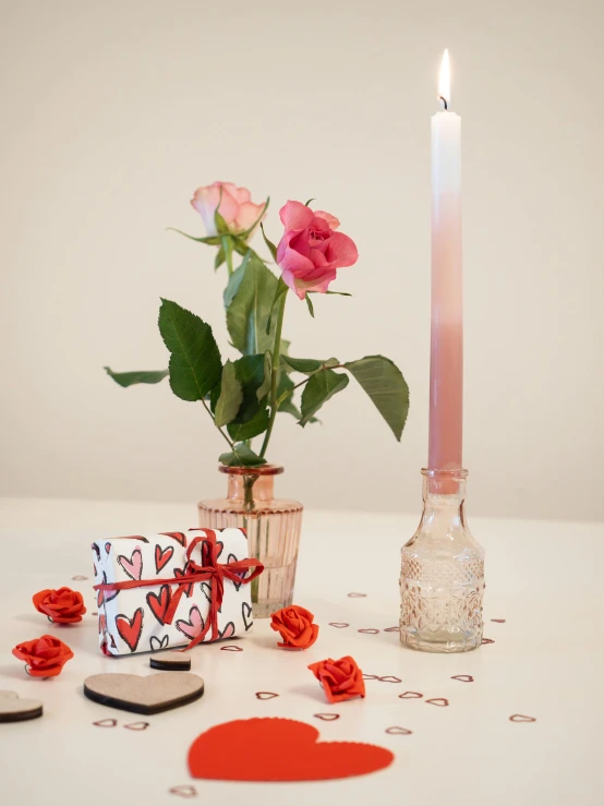 flowers and items on a table next to a candle