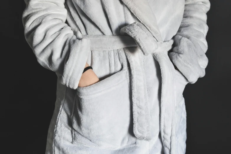 the back side of a person wearing a gray robe