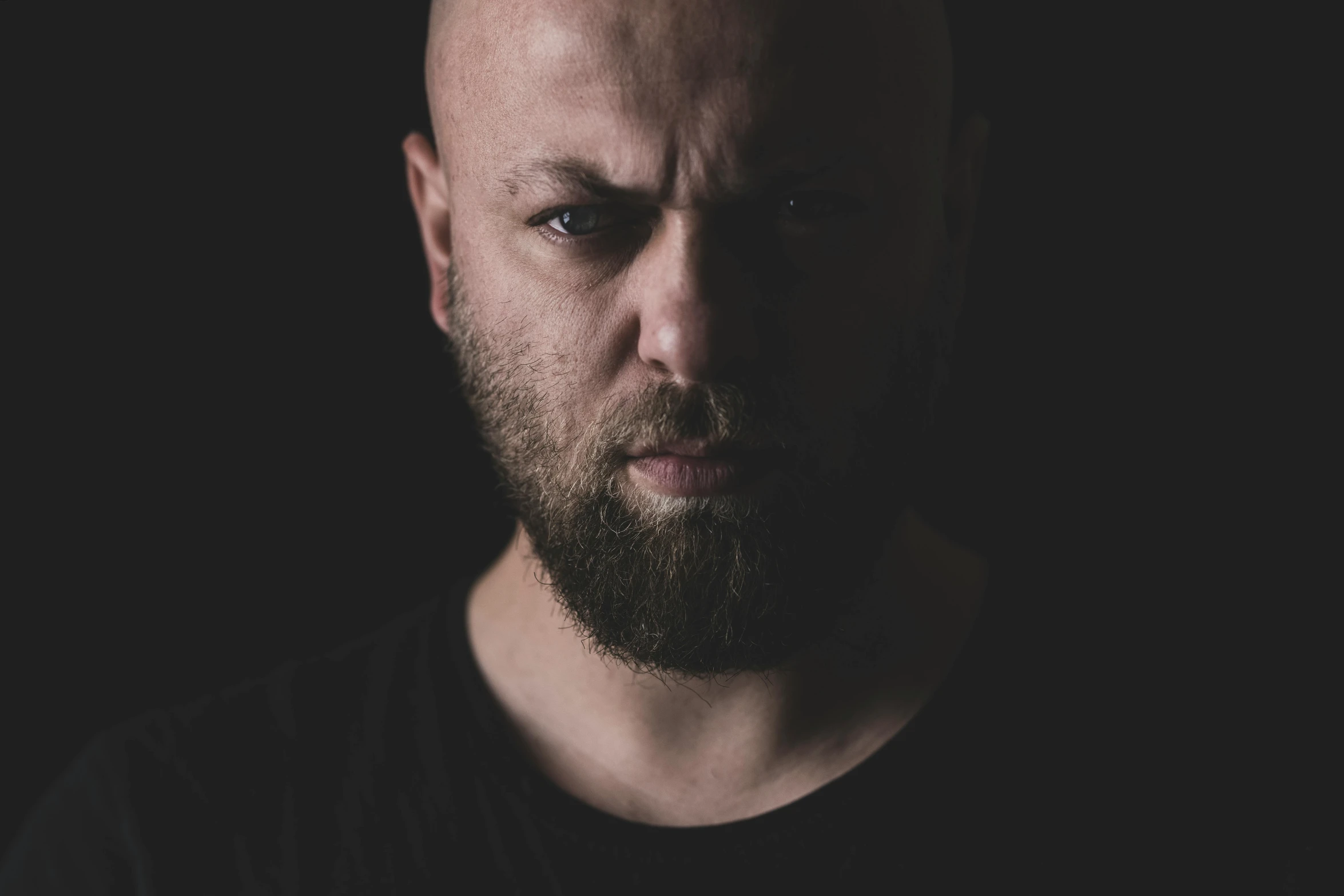 a man with a beard on a dark background