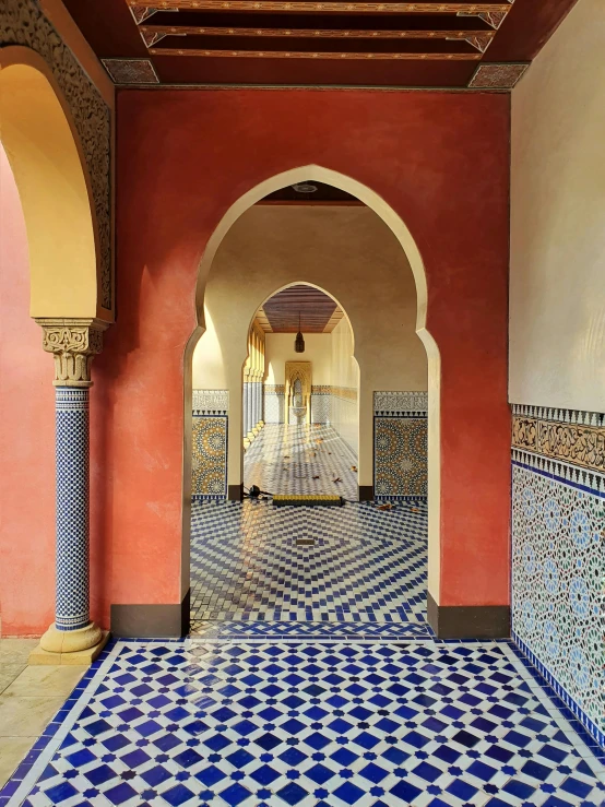 an archway leads into an area with intricate tile work