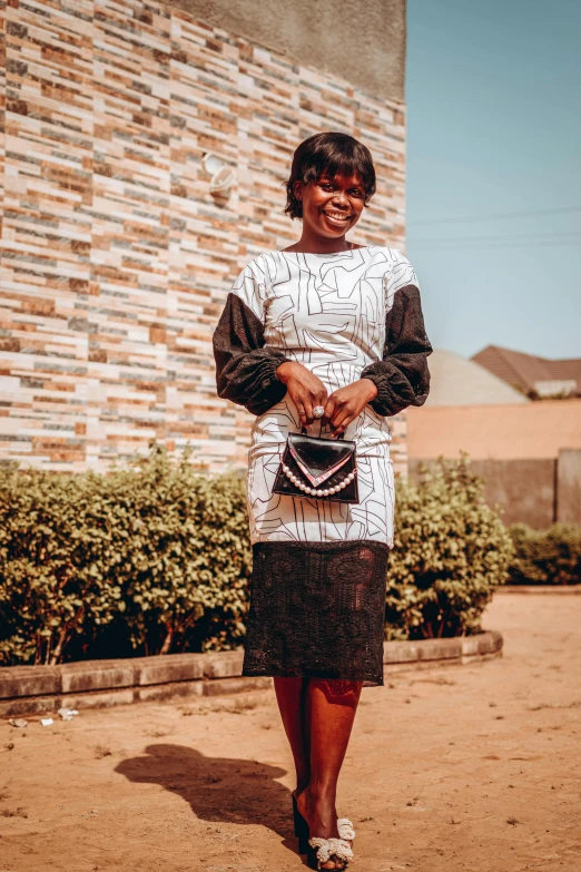 a woman is standing on the dirt outside