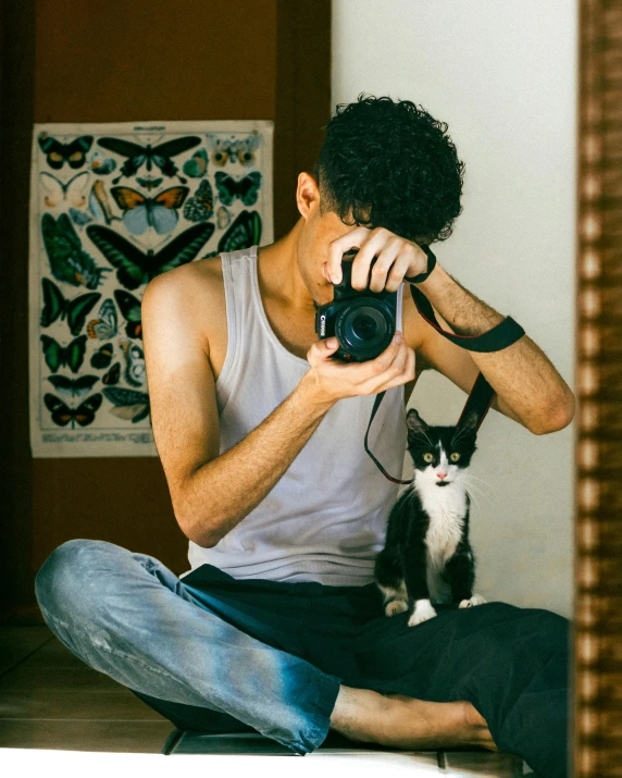 a man taking a po of a cat