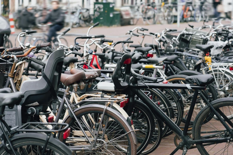 many bikes parked next to each other on the street