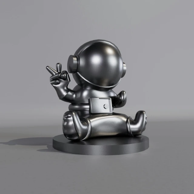 the small metal toy is sitting down