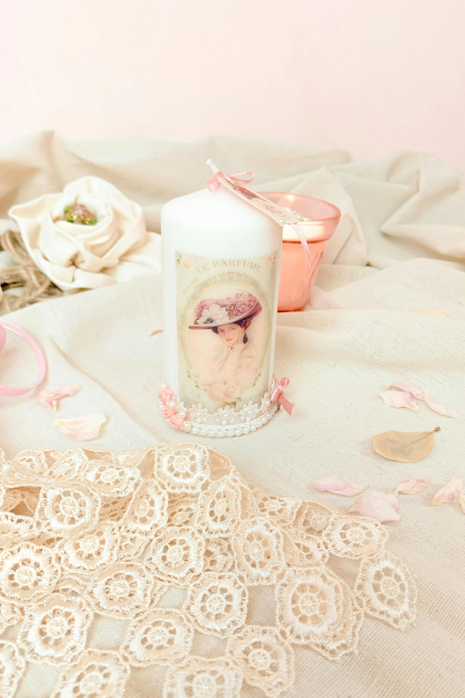 a white candle and some laces on a table