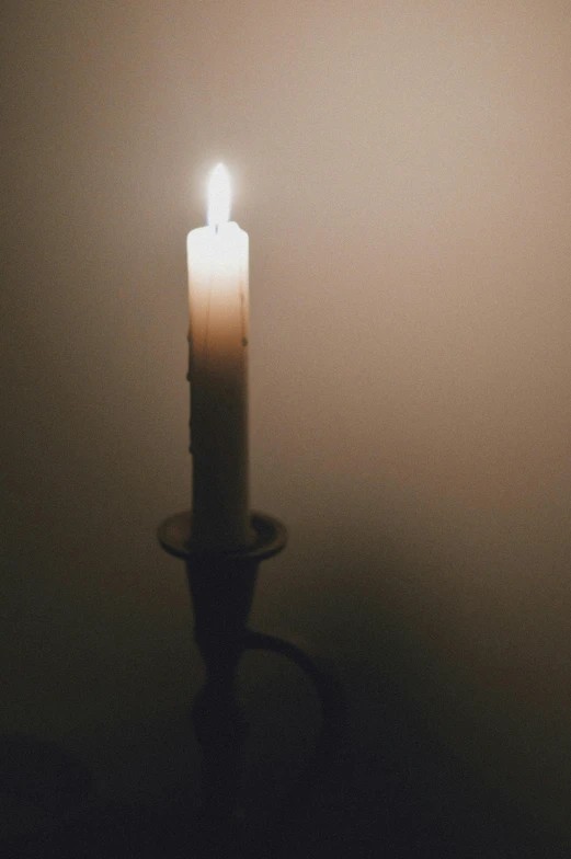 a candle lit up with a light in it