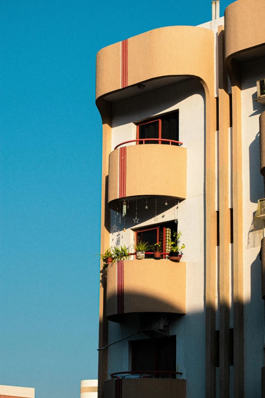 a building that has some windows and plants on it