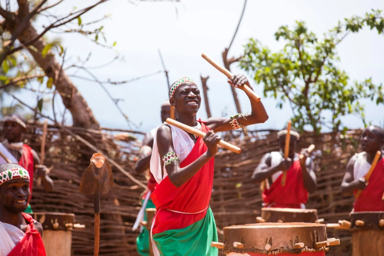 an african drummer with a drum set in front of him