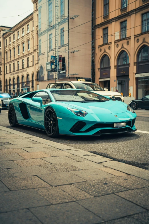 a car parked on the side of a road in front of some buildings