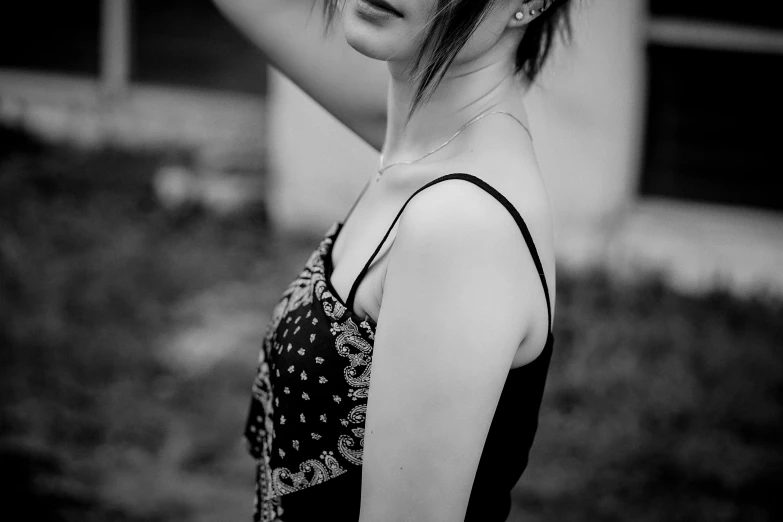 a woman that is standing in the grass with a hat on