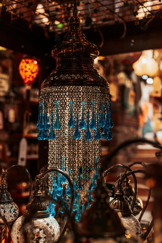 an ornate light fixture in front of a bar