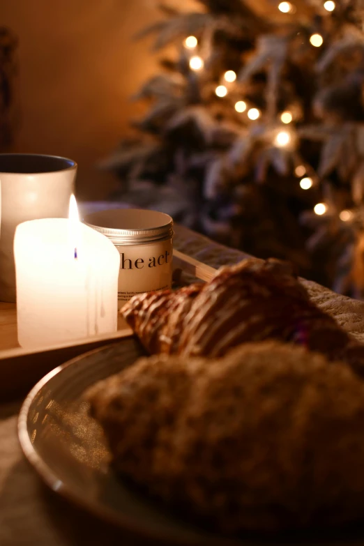 some cookies on a plate with a cup of coffee in front of the tree