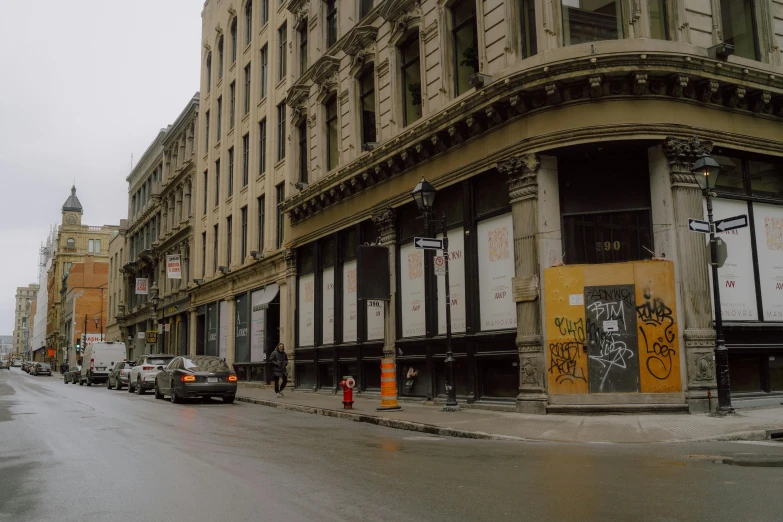 an empty city street with a brown building