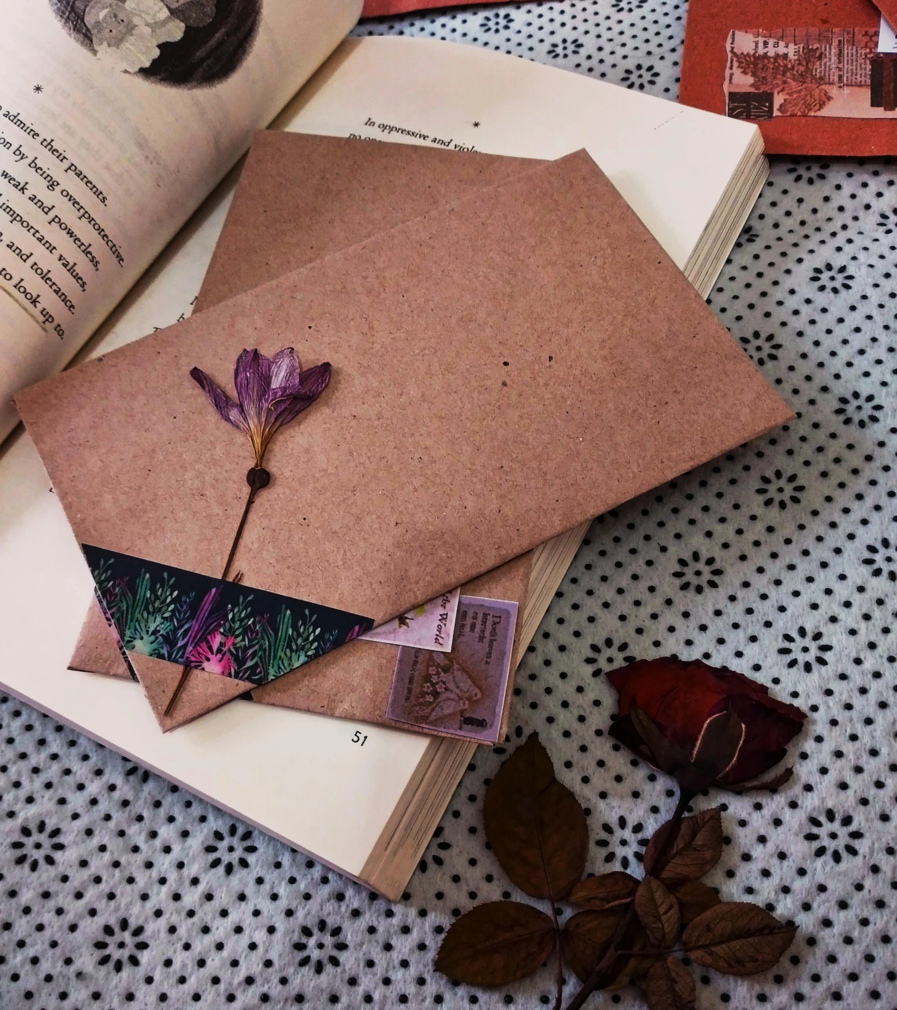 a very old book with a flower on top of it