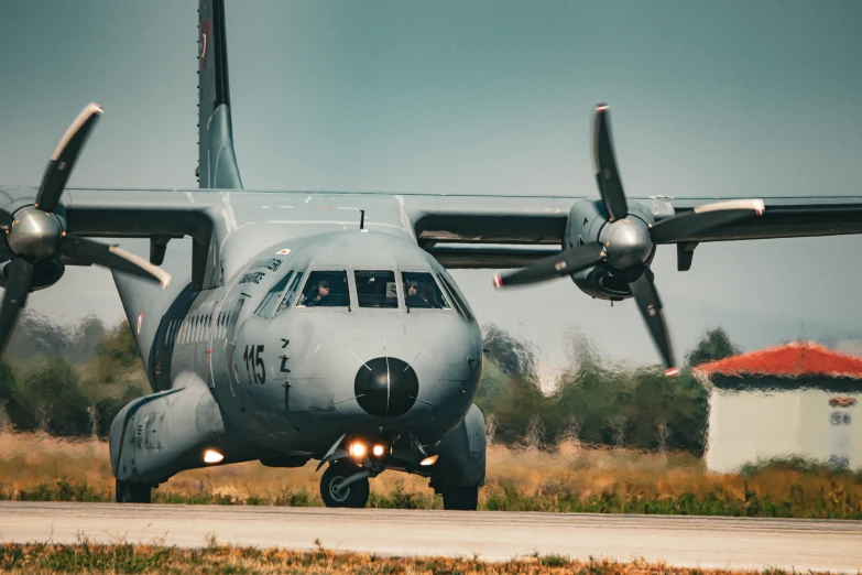 a large propeller airplane is on the runway