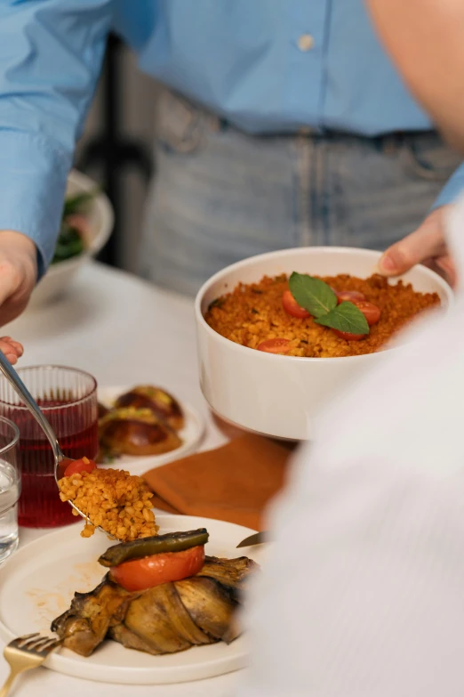 someone holding up a plate of food and reaching for it