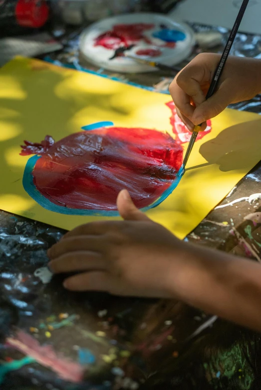 someone is working on an art project on yellow paper