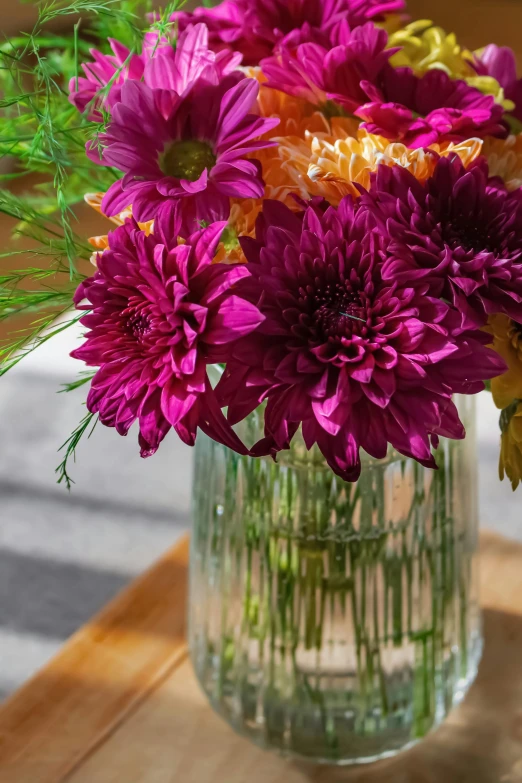 a vase full of purple and orange flowers