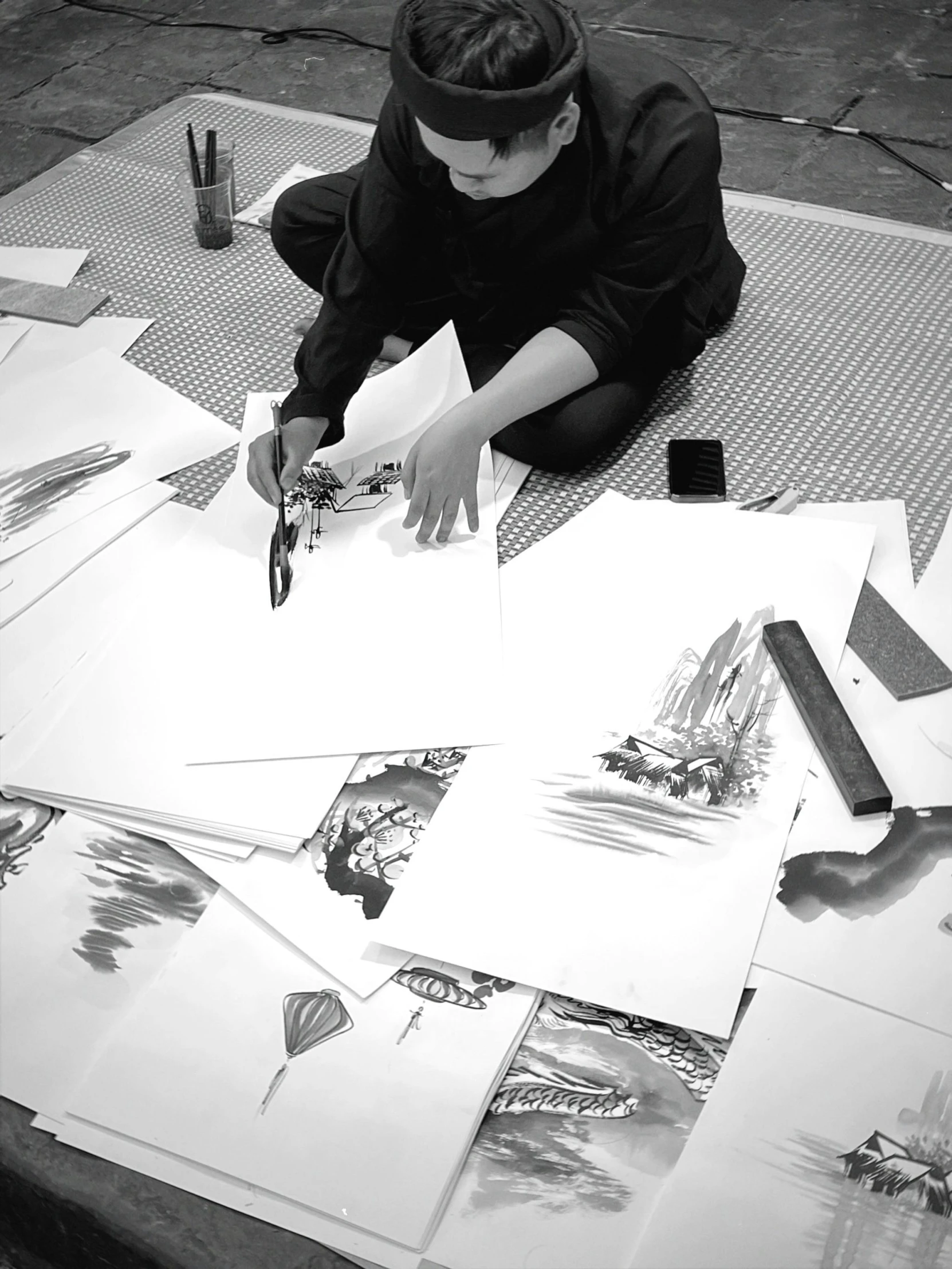 a woman laying on a table making art work