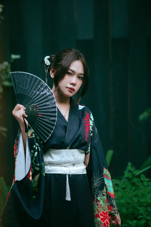 the girl in an oriental garb holds a fan